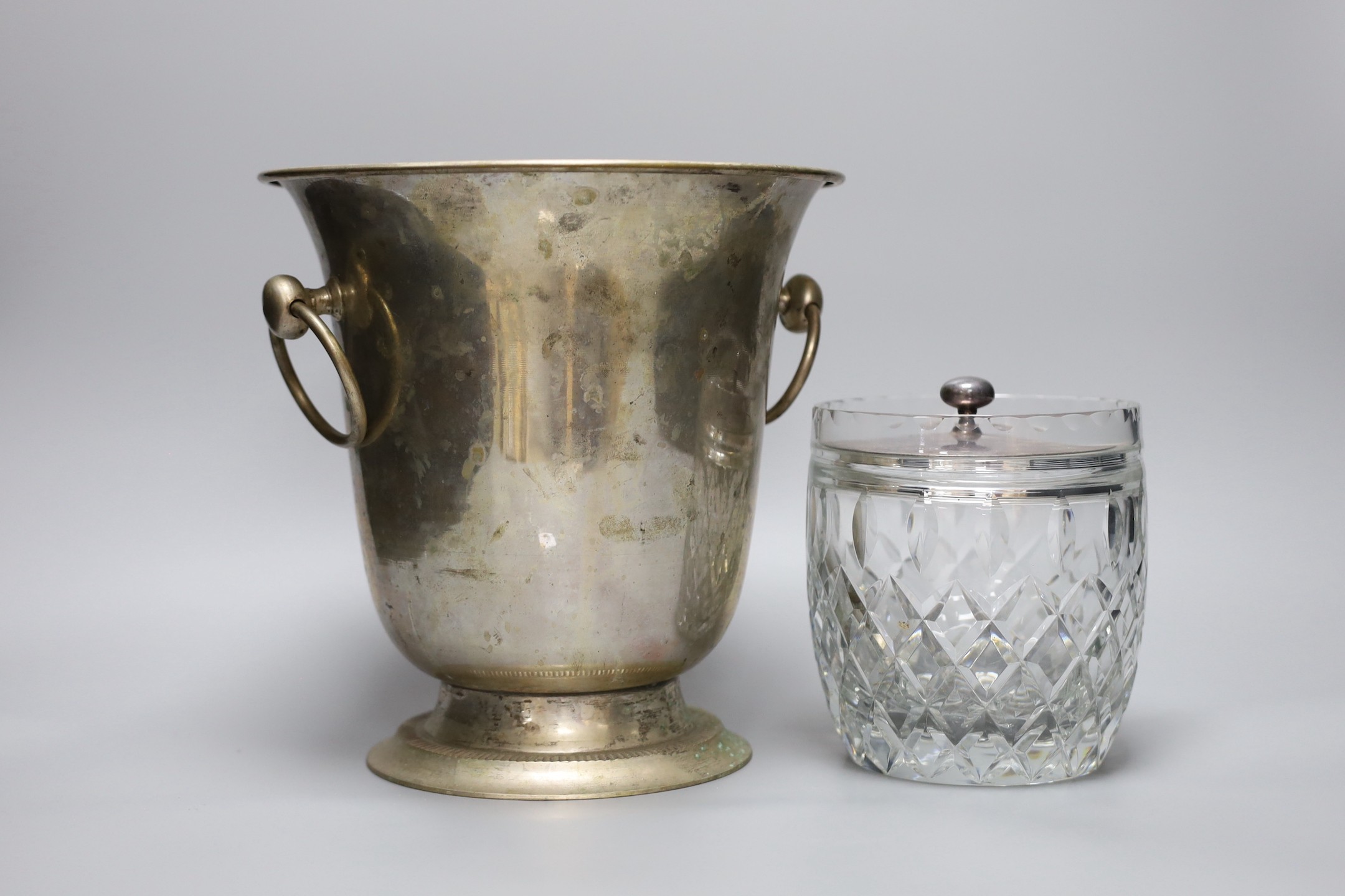 A silver plated wine cooler, a silver topped decanter and a silver lidded cut glass biscuit barrel